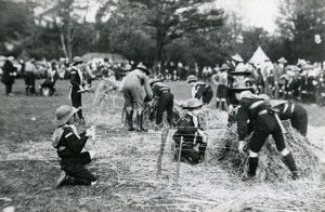 Group of boys from the Harvey Goodwin Home at a Scout camp 'making straw mattressess', c1913.