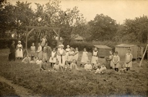 Twenty four girls and 5 members of staff in the garden of the Eastnor Home in 1920