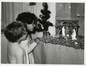 Two girls looking at a nativity display in one of The Society's homes, 1950s