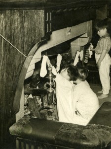 Hanging up Christmas stockings, 1950s 