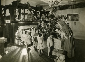 Children in a Society home in the 1940s receive a present from Father Christmas