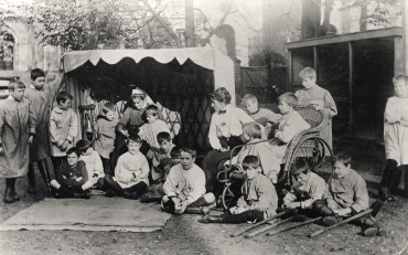 Boys and staff in the garden at St. Martin's Home for Boys, Surbiton, Surrey