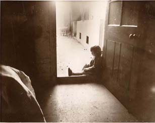 This little girl has found a quiet place to sit and think. Peaceful moments could be hard to find in a busy children's home.