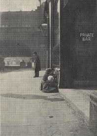 Young children huddled together on the pavement