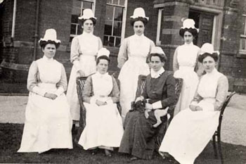 High cotton bonnets were part of a traditional matron's outfit, and made them instantly recognisable. The dark dress of the lady with the puppy, marks her out as the Head Matron. 