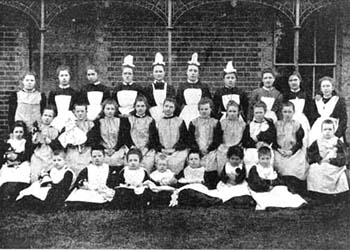 Smocks and pinafores were the ideal clothing for girls' homes, because they could be used for housework and were easily cleaned. They were also smart enough to wear for informal group portraits, as this photograph shows.