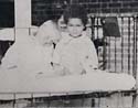 Children outdoors in a cot