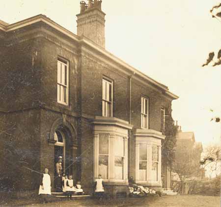 Girls and staff at the front of the home