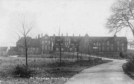 A winter scene showing the sweeping drive leading up to the Home