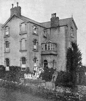 Informal photograph of the Matron and girls outside