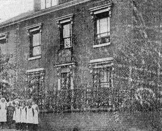 The girls pose outside the Home