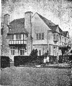 Two girls stand outside the front of St Monica's