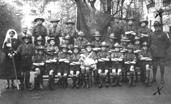 St George's pet dog earns his badges with the Home's Scout troop. Pets were often treated as mascots for a home, accompanying the children on their travels.