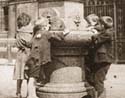 Children drinking from  fountain