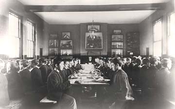 Meal time was often a very formal affair with the children all sat in a hierarchical order. In this photograph, the Master of the Standon Home sits at the head of the middle table.